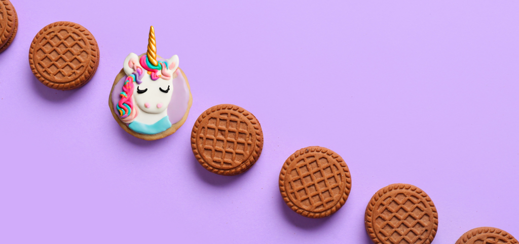 picture of a line of boring, similar cookies. and then, standing out from the rest is a colorful unicorn cookie
